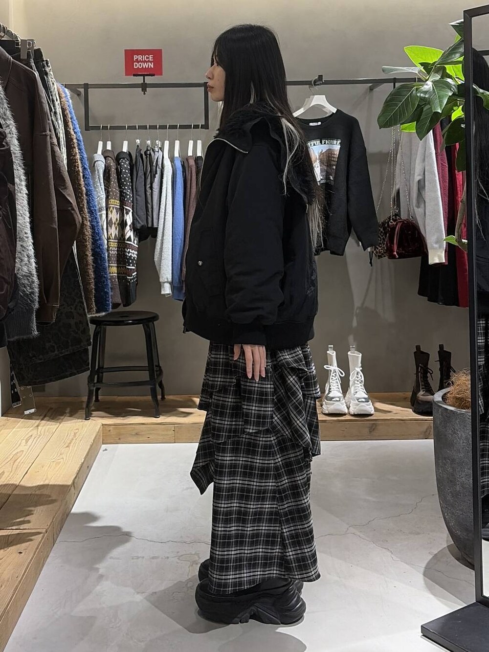 ブラック系のブーツ、ブラック系のブルゾン、レッド系のスウェットを着用したレディースの冬コーディネートの2枚目の写真