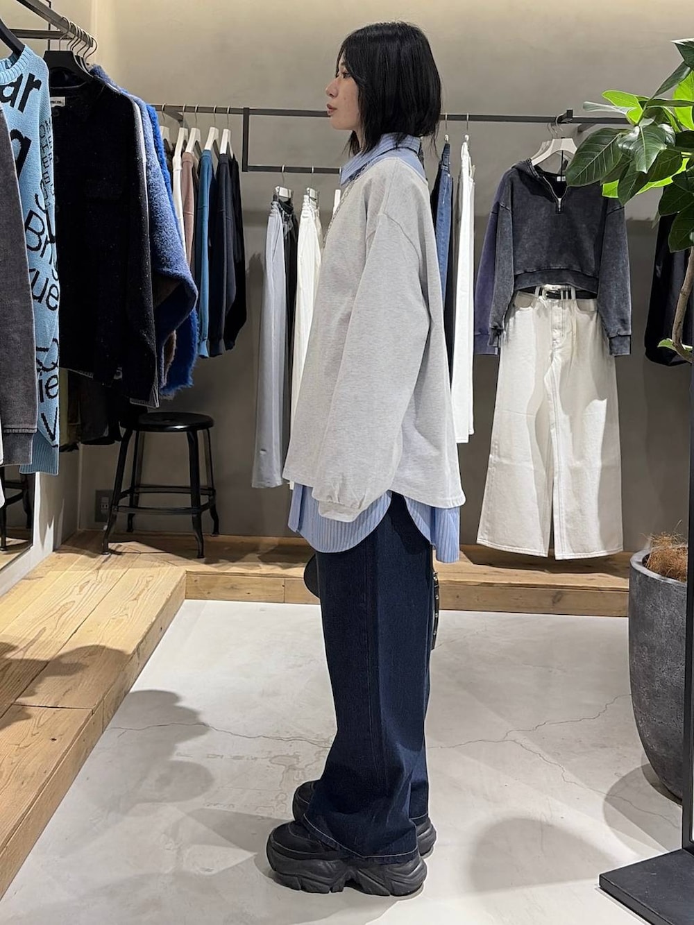 ブラック系のブーツ、ブルー系のスラックス、ブラック系のハンドバッグを着用したレディースの冬コーディネートの2枚目の写真