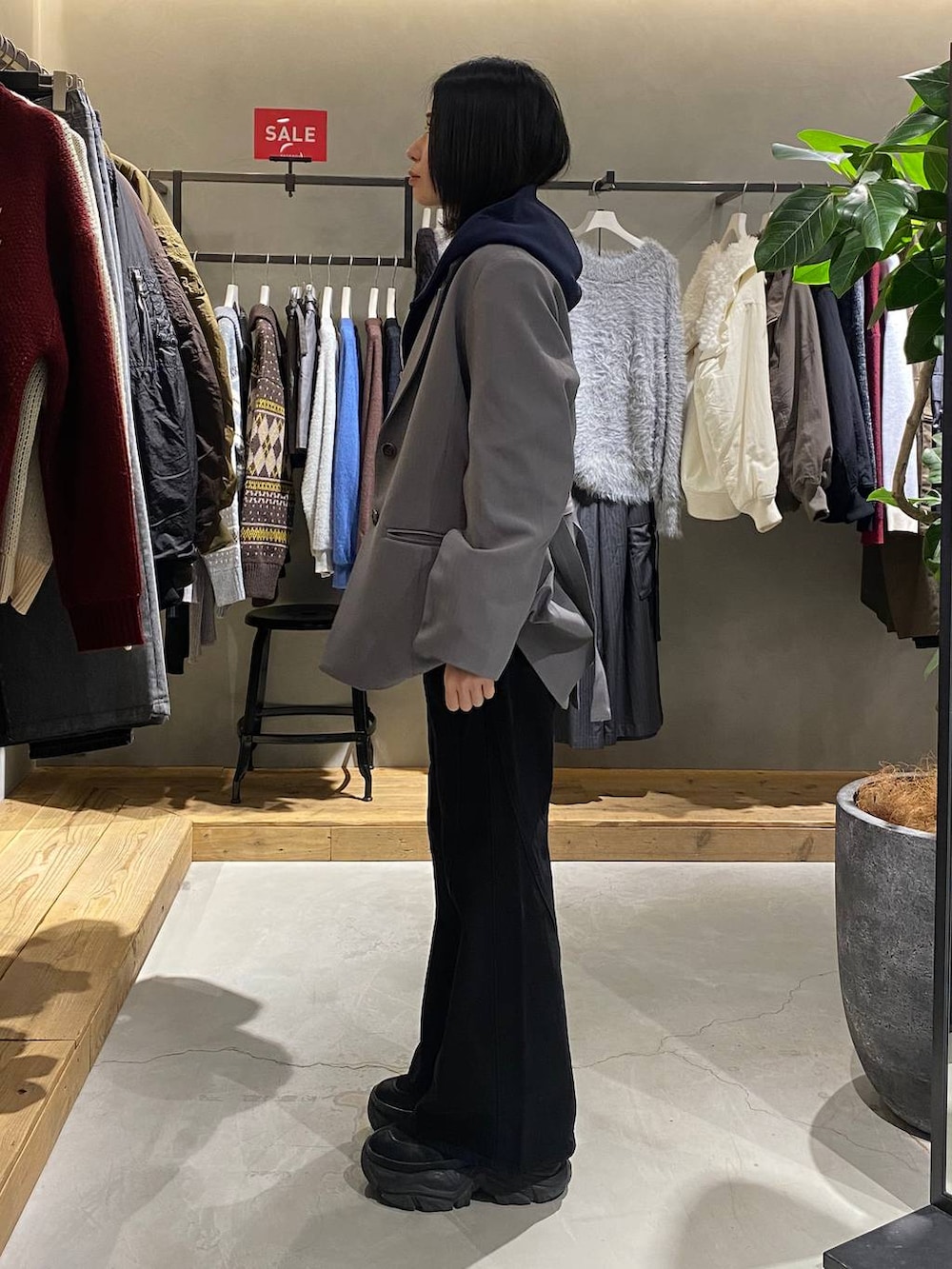 ブラック系のデニムパンツ、ホワイト系のTシャツ/カットソー、グレー系のテーラードジャケットを着用したレディースの冬コーディネートの2枚目の写真