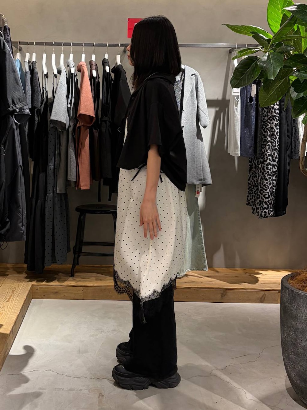 ホワイト系のチュニック、ブラック系のデニムパンツ、グレー系のTシャツ/カットソーを着用したレディースの夏コーディネートの2枚目の写真