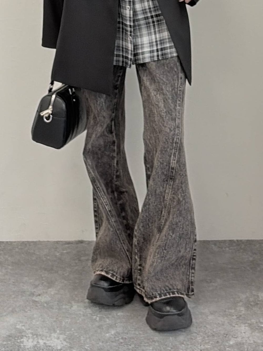 ブラック系のブーツ、ブラック系のボストンバッグ、ブラック系のテーラードジャケットを着用したレディースの春コーディネートの5枚目の写真