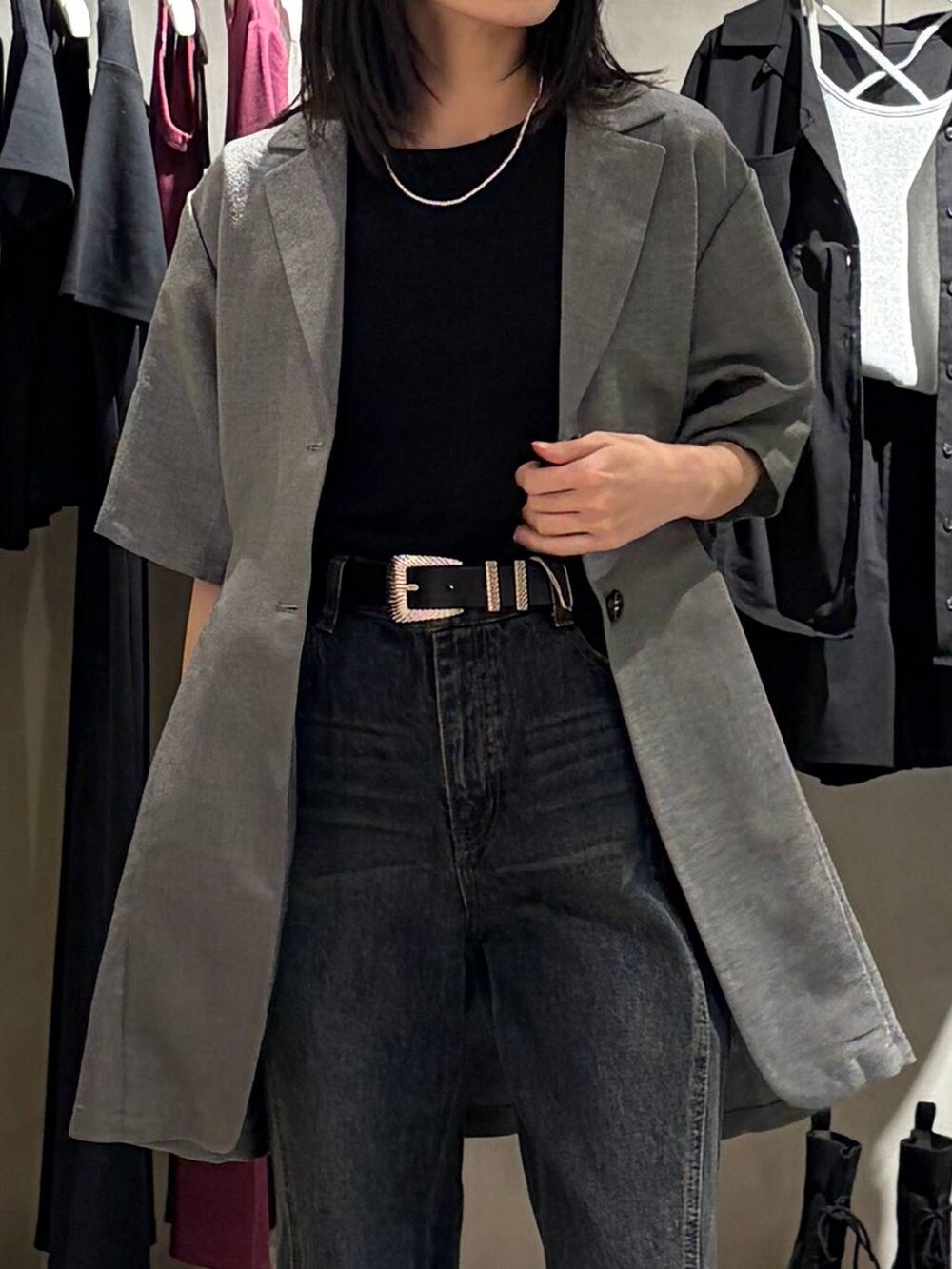 ブルー系のデニムパンツ、ブラック系のサンダル、ブラック系のTシャツ/カットソーを着用したレディースの春コーディネートの4枚目の写真
