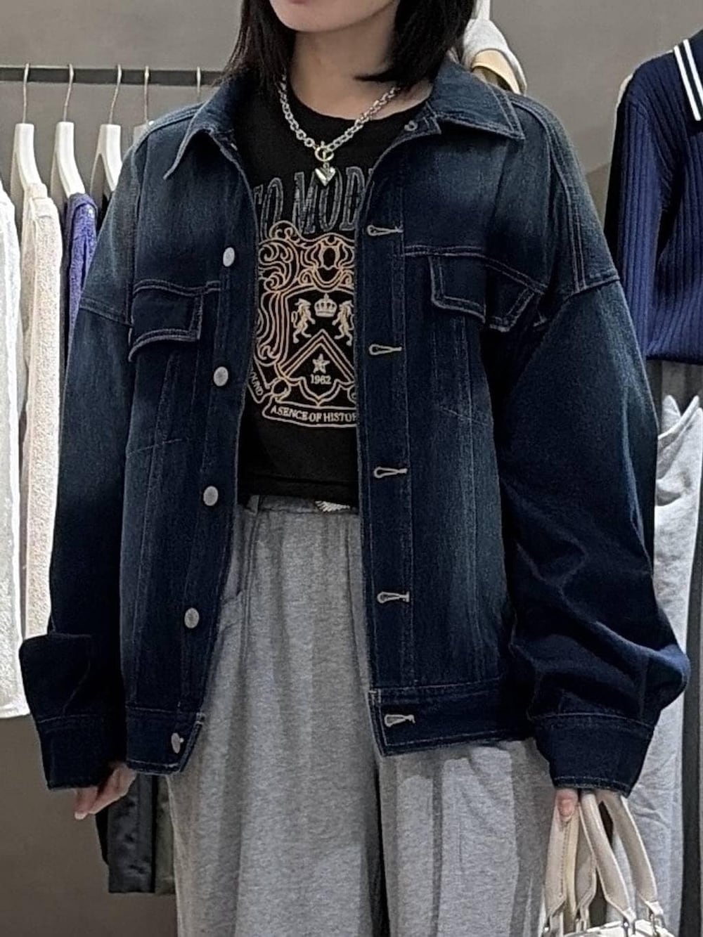 ブラック系のブーツ、ホワイト系のボストンバッグ、グレー系のスウェットを着用したレディースの冬コーディネートの4枚目の写真