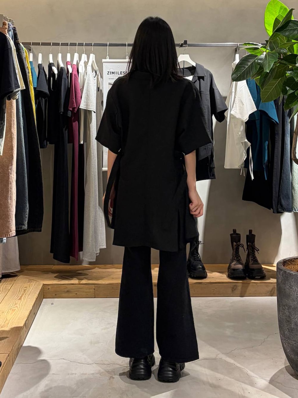 ブラック系のスニーカー、ブラック系のデニムパンツ、ブラック系のテーラードジャケットを着用したレディースの春コーディネートの3枚目の写真