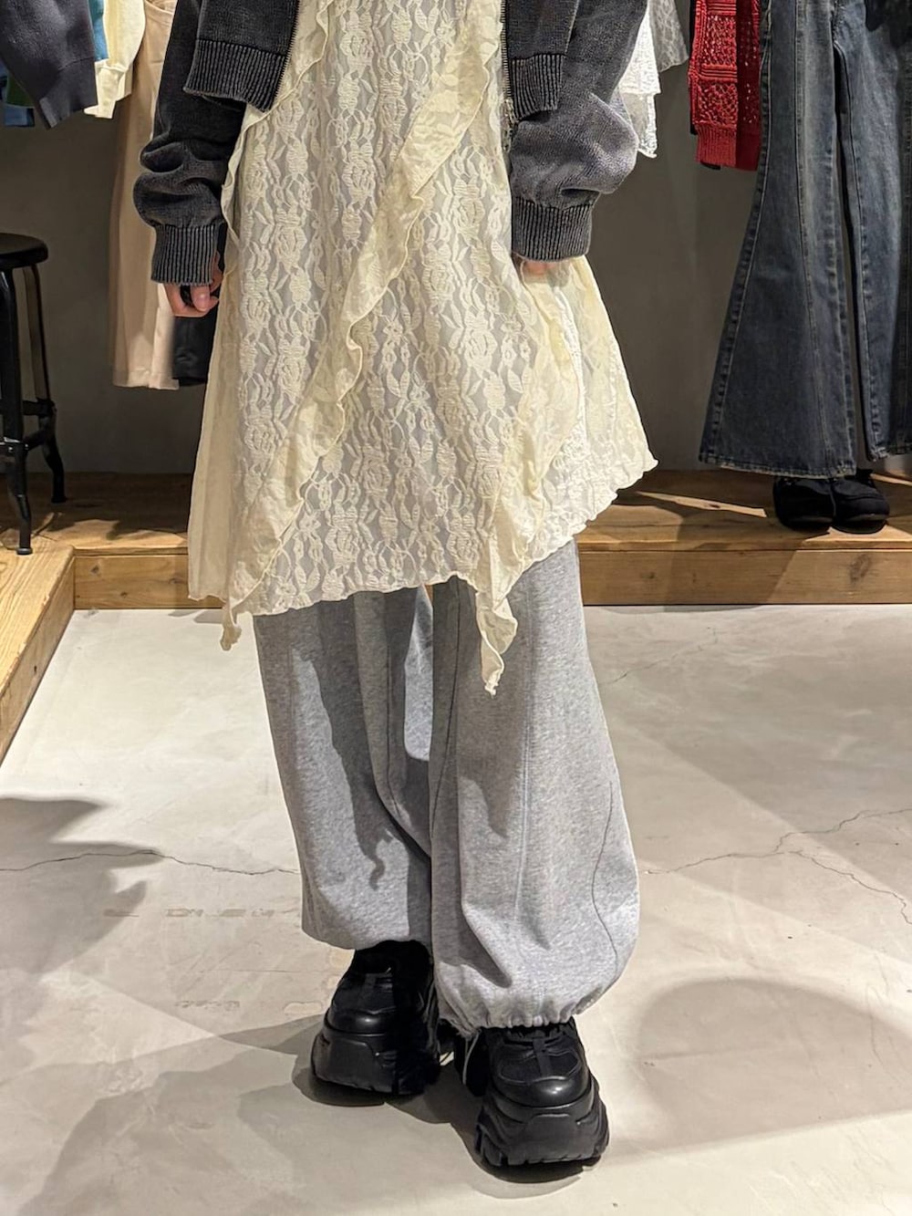 ブラック系のブーツ、グレー系のスウェットパンツ、グレー系のパーカーを着用したレディースの春コーディネートの5枚目の写真