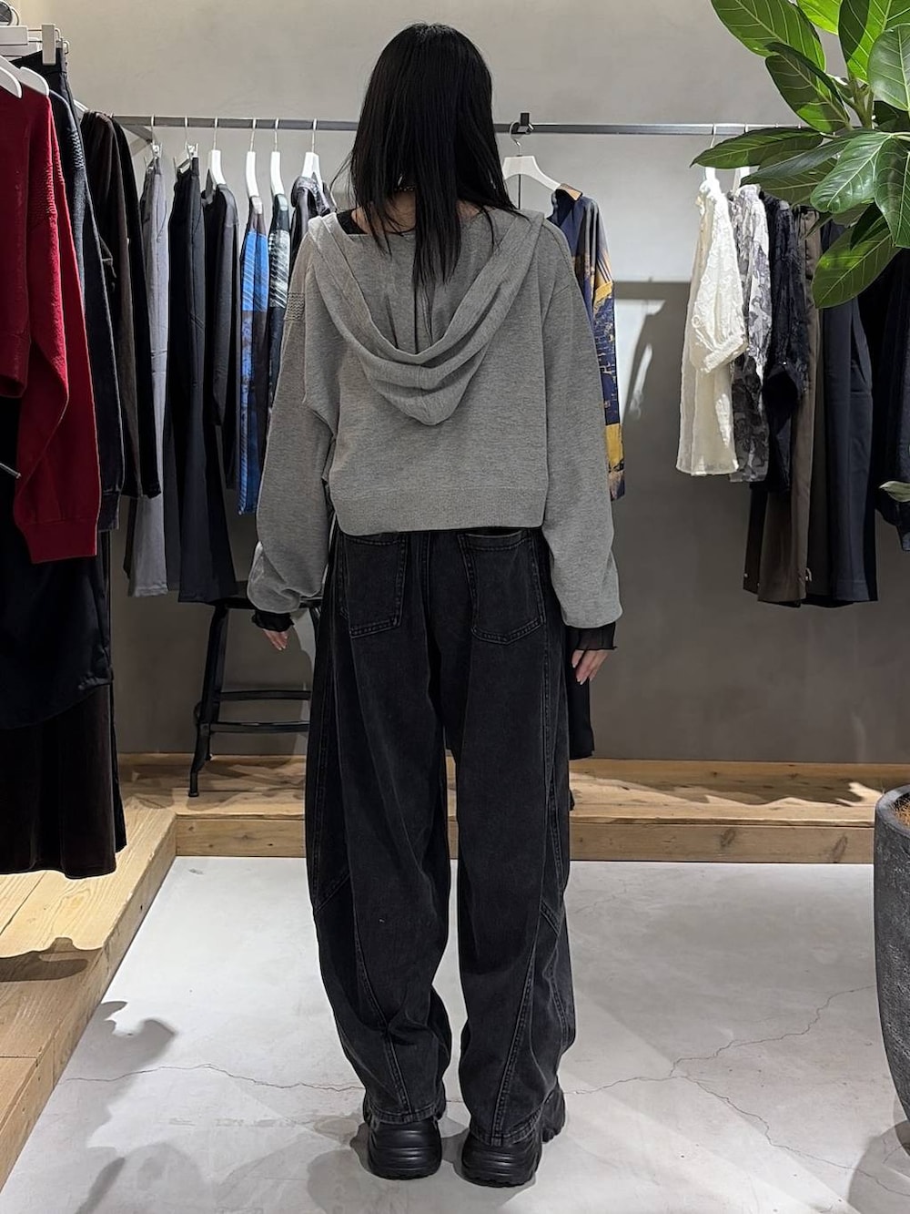 グレー系のパーカー、ブラック系のシャツ/ブラウス、ブラック系のデニムパンツを着用したレディースの秋コーディネートの3枚目の写真