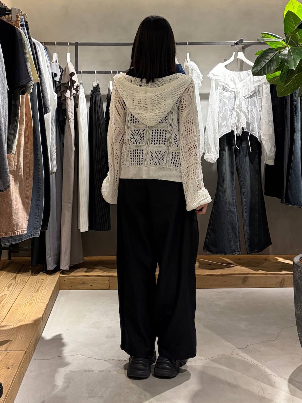 ブラック系のブーツ、ホワイト系のパーカー、ブラック系のその他パンツを着用したレディースの春コーディネートの3枚目の写真