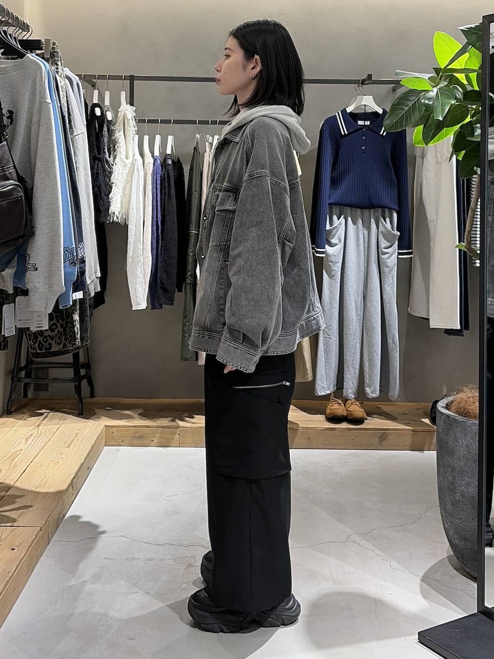 ブラック系のブーツ、グレー系のパーカー、ブラック系のブルゾンを着用したレディースの冬コーディネートの2枚目の写真