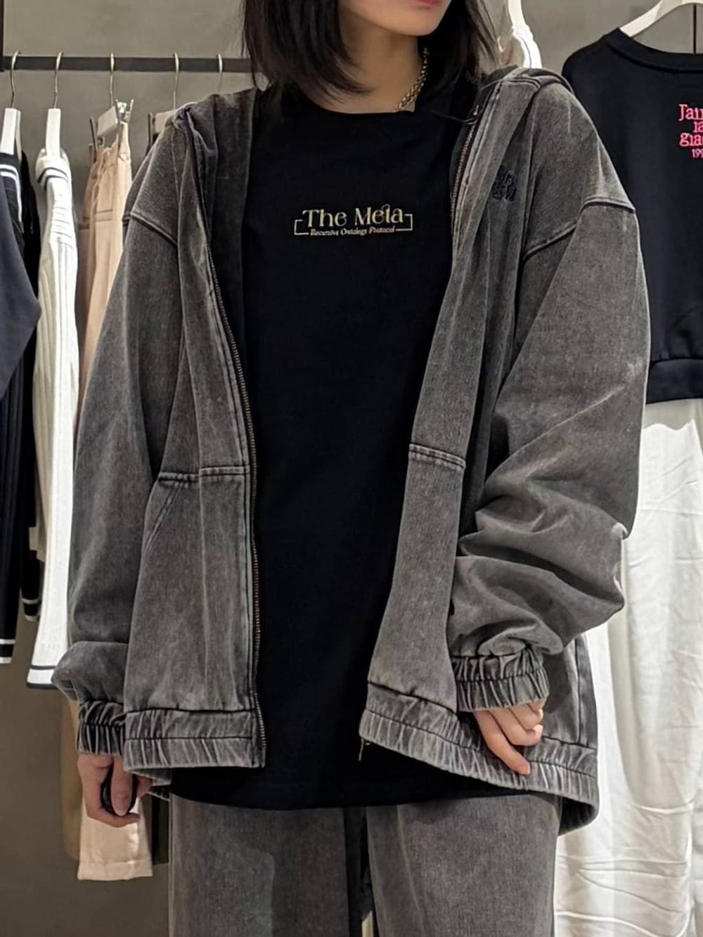 ブラック系のブーツ、ブラック系のデニムパンツ、ブラック系のパーカーを着用したレディースの春コーディネートの4枚目の写真