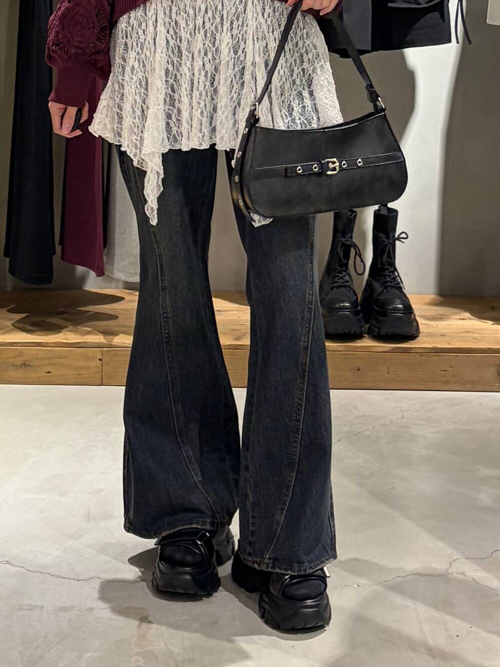 パープル系のカーディガン/ボレロ、ブルー系のデニムパンツ、ブラック系のハンドバッグを着用したレディースの春コーディネートの5枚目の写真