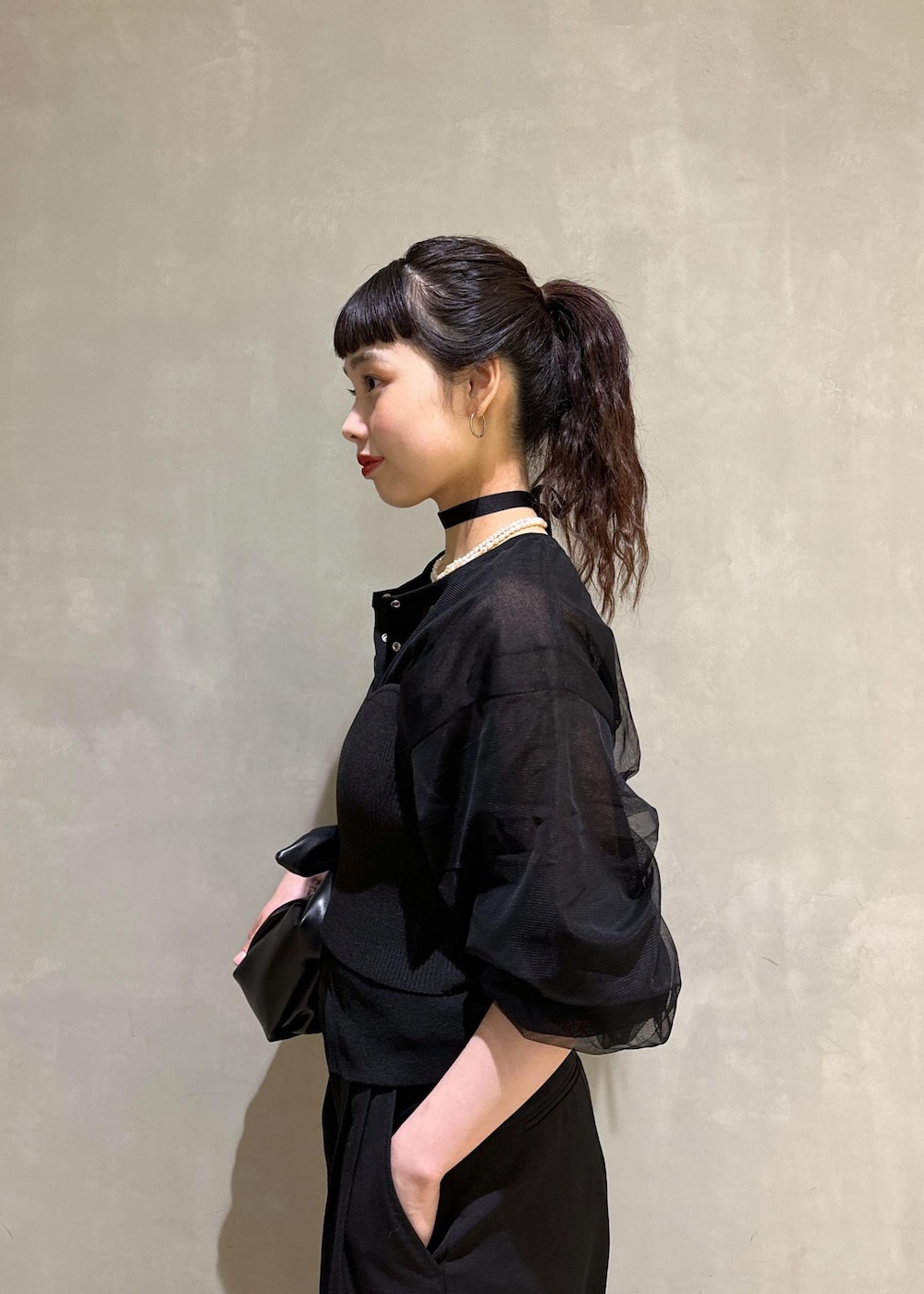 ブラック系のカーディガン/ボレロ、ブラック系のスラックス、ブラック系のショルダーバッグを着用したレディースの夏コーディネートの6枚目の写真