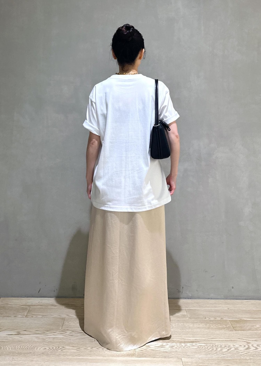 ブラック系のサンダル、ホワイト系のスカート、ブラック系のハンドバッグを着用したレディースの夏コーディネートの4枚目の写真