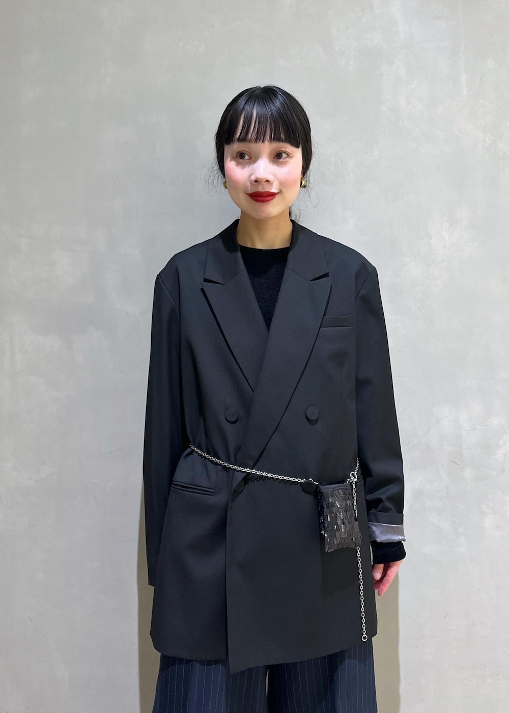 ブラック系のショルダーバッグ、ブラック系のテーラードジャケット、ブラック系のTシャツ/カットソーを着用したレディースの冬コーディネートの6枚目の写真