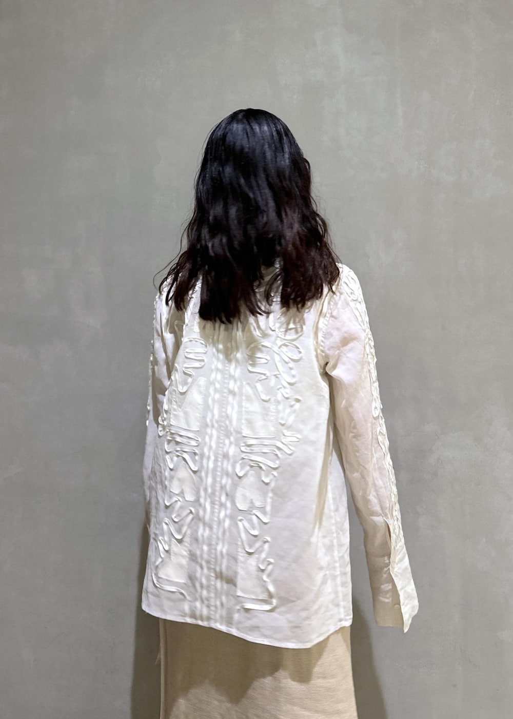 ベージュ系のスカート、ホワイト系のシャツ/ブラウス、ブルー系のデニムパンツを着用したレディースの冬コーディネートの8枚目の写真