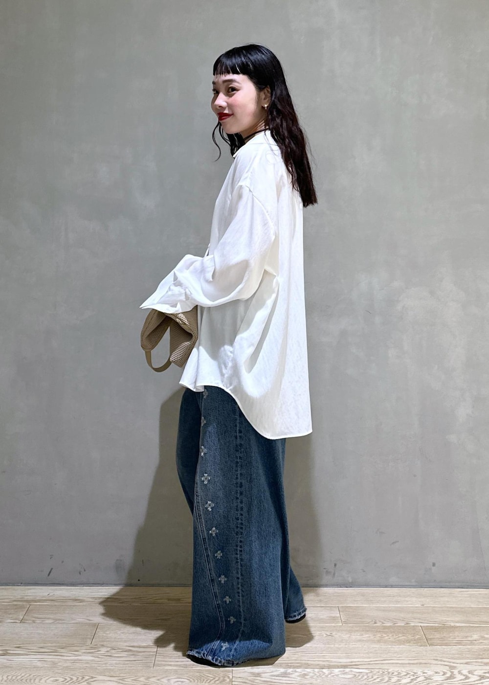 ベージュ系のショルダーバッグ、ホワイト系のシャツ/ブラウス、ブラック系のサンダルを着用したレディースの春コーディネートの3枚目の写真