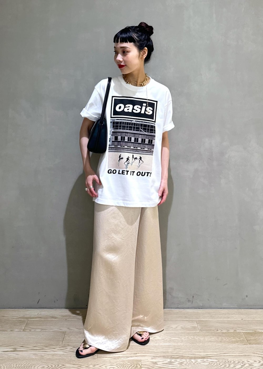 ブラック系のサンダル、ホワイト系のスカート、ブラック系のハンドバッグを着用したレディースの夏コーディネートの3枚目の写真