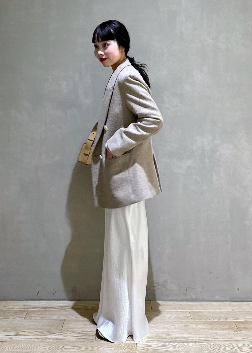 ホワイト系のTシャツ/カットソー、ベージュ系のその他アウター、ベージュ系のハンドバッグを着用したレディースの冬コーディネートの3枚目の写真