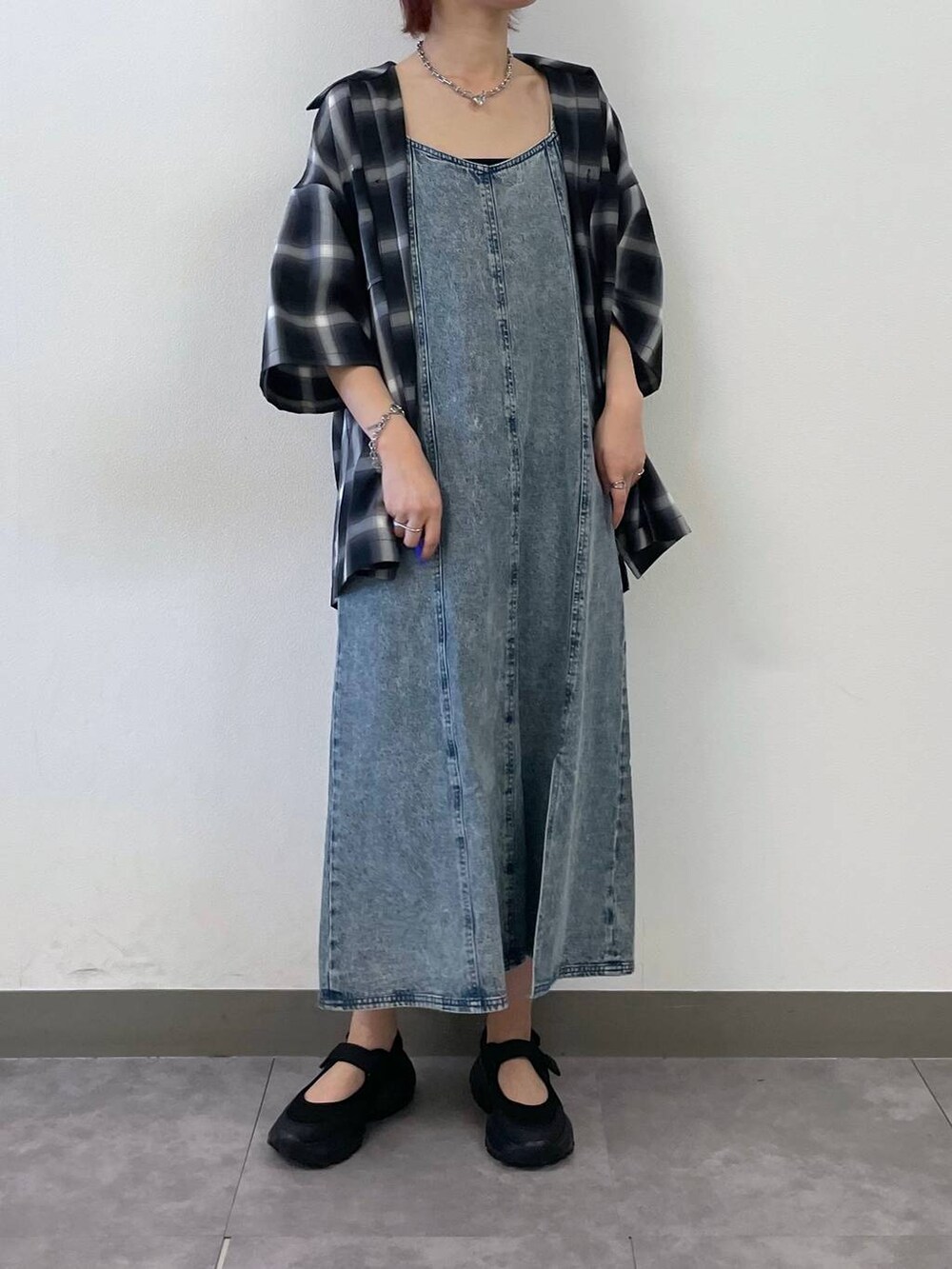 ブラック系のスニーカー、ブルー系のワンピース、シルバー系のブレスレットを着用したレディースの夏コーディネートの3枚目の写真