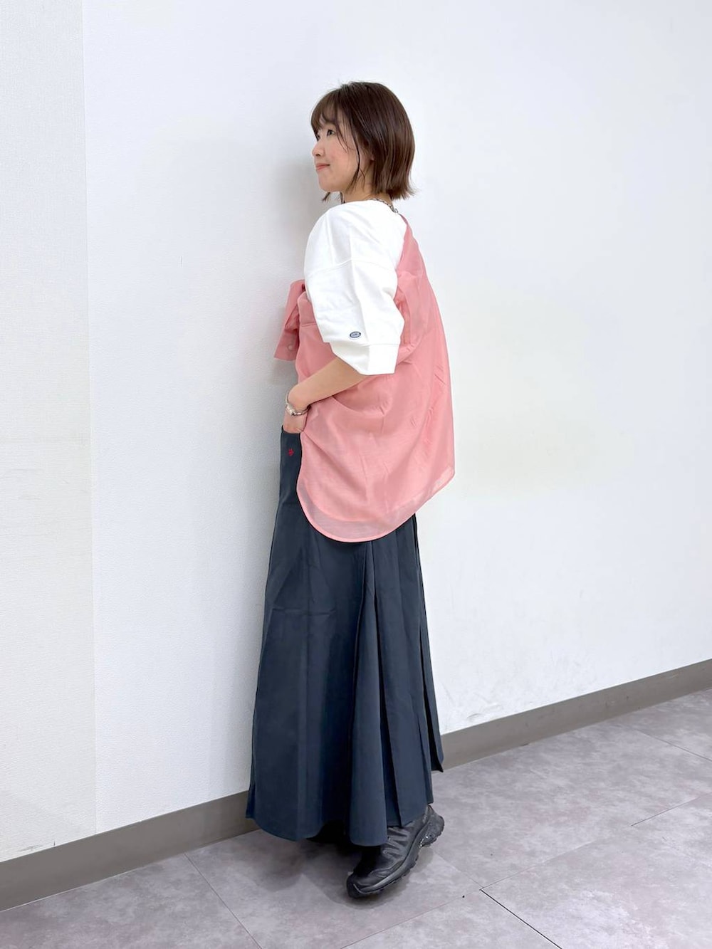 ホワイト系のTシャツ/カットソー、ブラック系のスニーカー、ブルー系のスカートを着用したレディースの春コーディネートの4枚目の写真