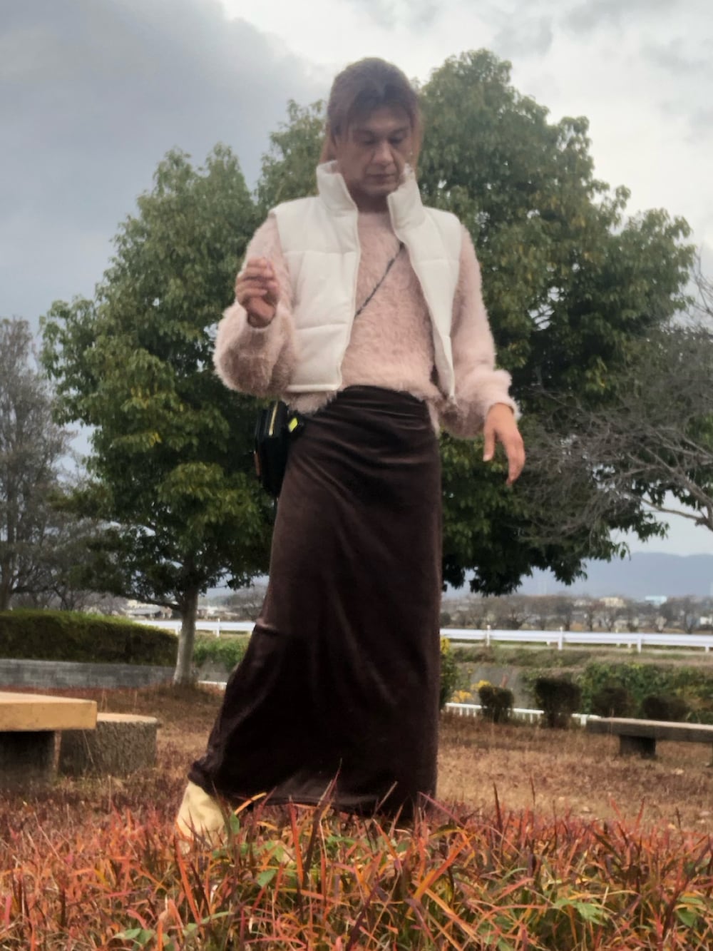 ブラック系のスカート、ベージュ系のブーツ、ピンク系のニット/セーターを着用したメンズの冬コーディネートの5枚目の写真