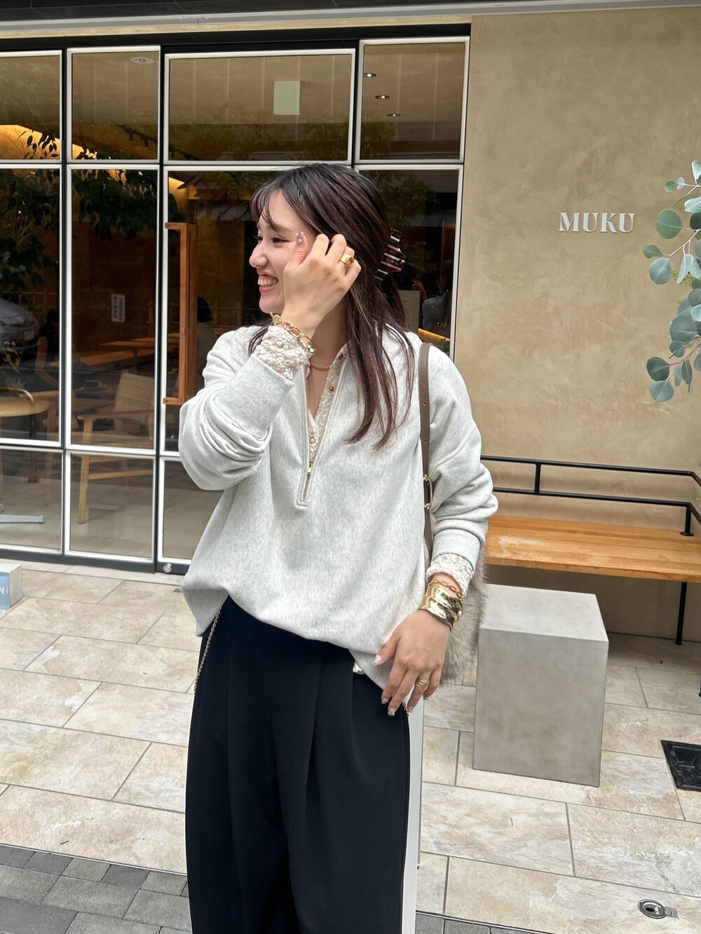 ベージュ系のスウェット、ブラック系のその他パンツ、ホワイト系のシャツ/ブラウスを着用したレディースの秋コーディネートの2枚目の写真