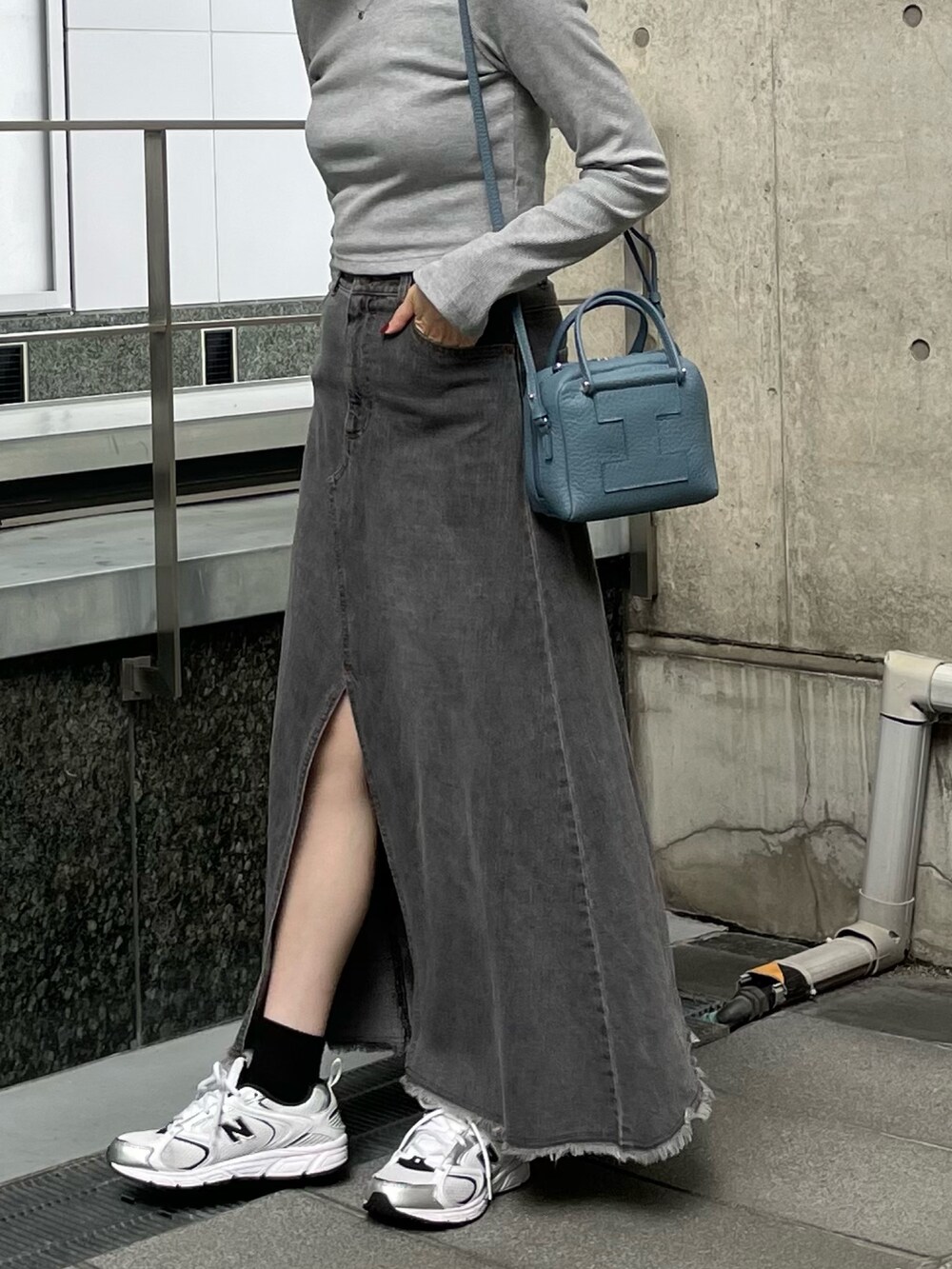 ブルー系のトートバッグを着用したレディースの秋コーディネートの2枚目の写真