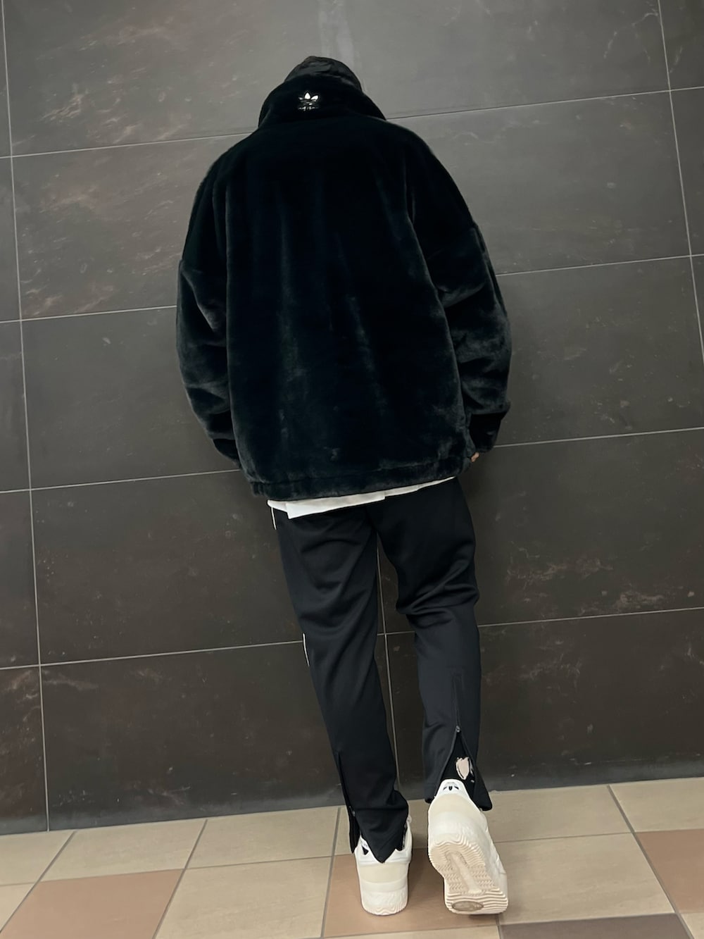 ブラック系のブルゾン、ブラック系のスウェットパンツ、ホワイト系のスニーカーを着用したメンズの秋コーディネートの4枚目の写真