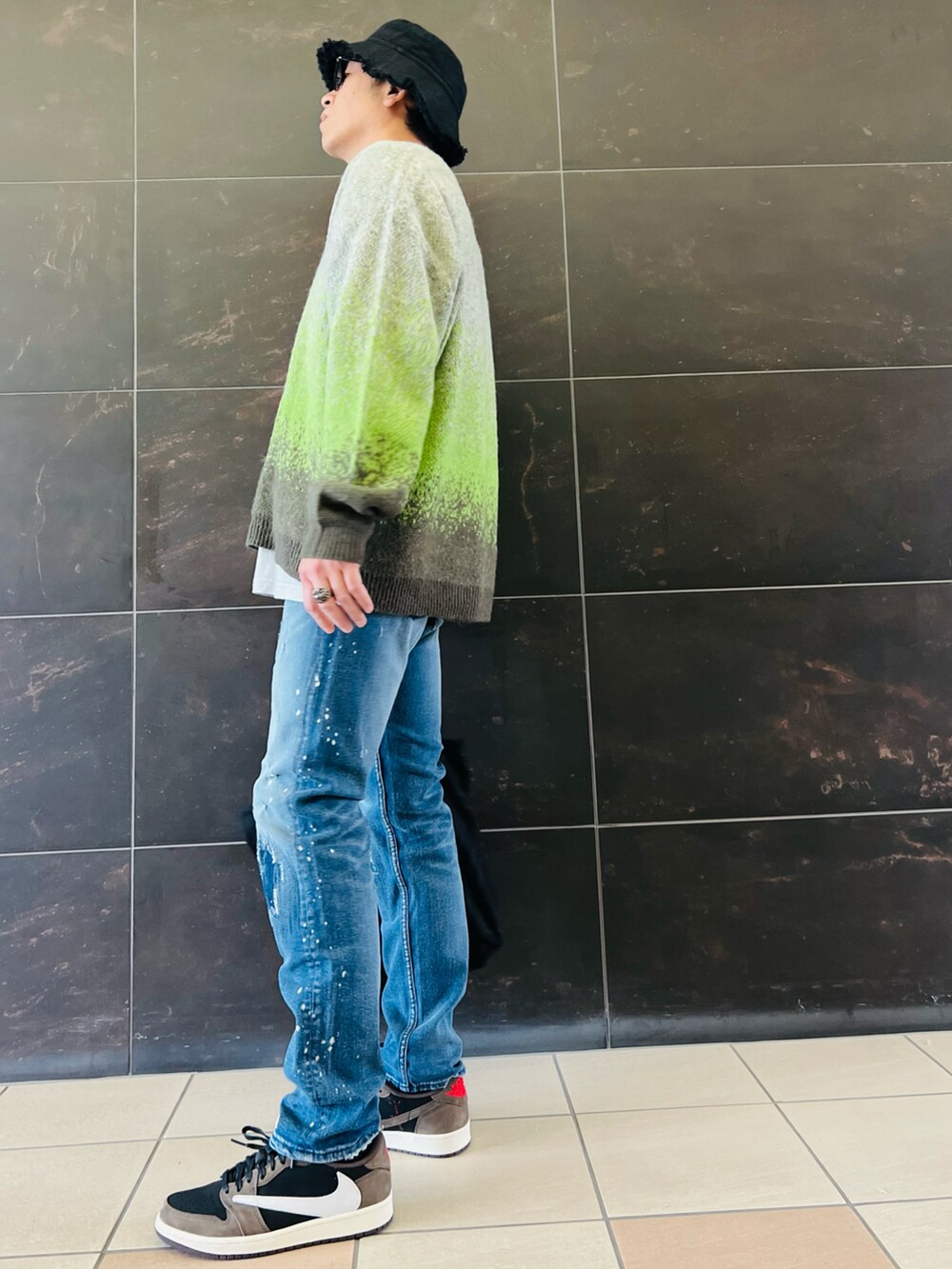 グリーン系のカーディガン/ボレロ、グレー系のTシャツ/カットソー、ブルー系のデニムパンツを着用したメンズの秋コーディネートの2枚目の写真