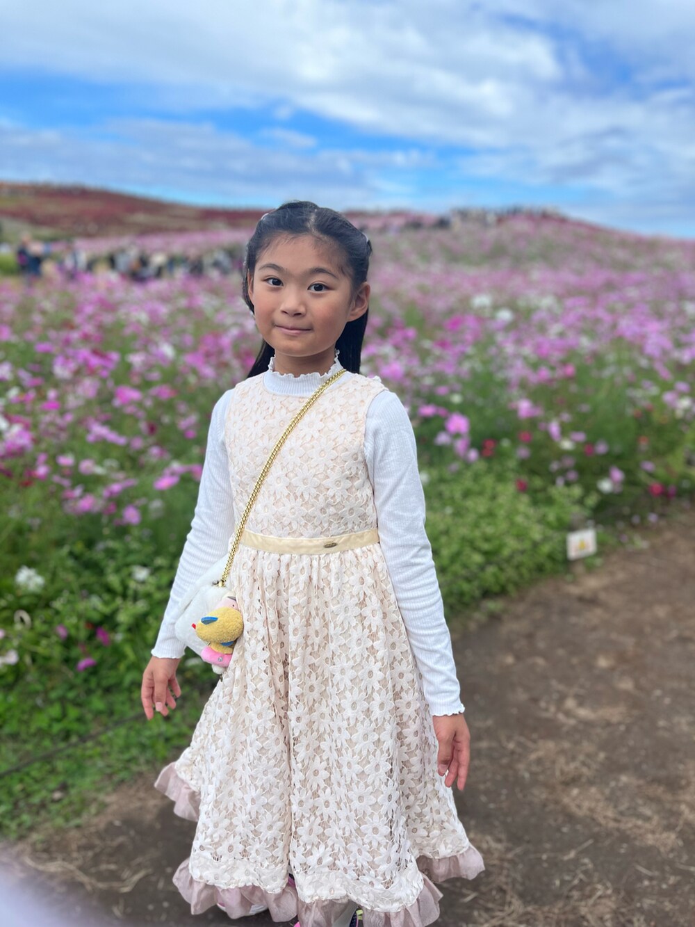 ホワイト系のドレスを着用したキッズの秋コーディネートの2枚目の写真