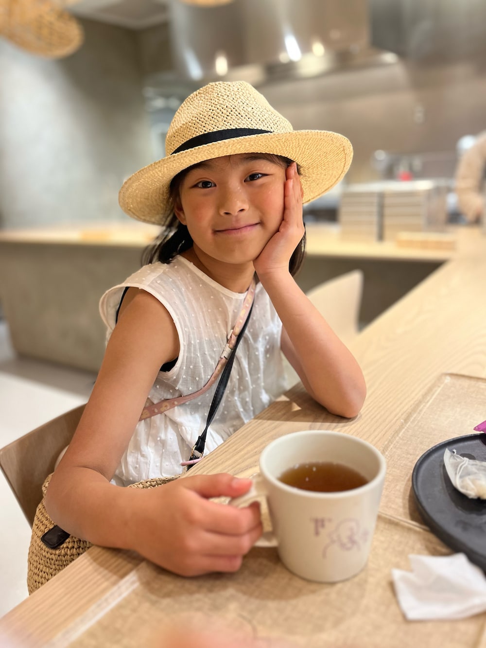 ホワイト系のワンピース、ベージュ系のハットを着用したキッズの春コーディネートの5枚目の写真