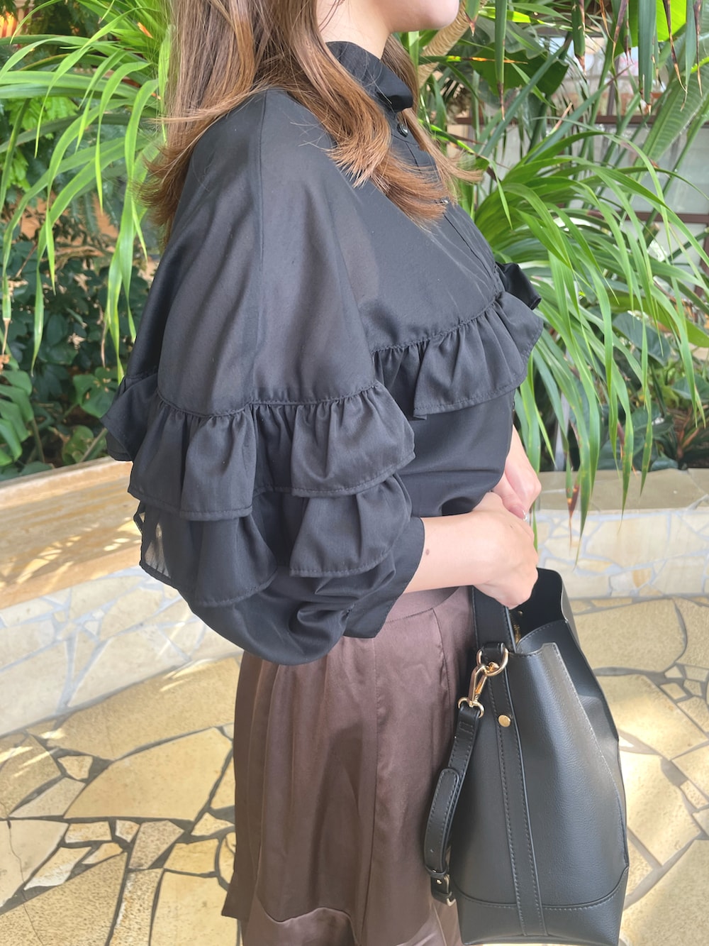 ブラウン系のスカート、ブラック系のハンドバッグ、ブラック系のシャツ/ブラウスを着用したレディースの秋コーディネートの4枚目の写真