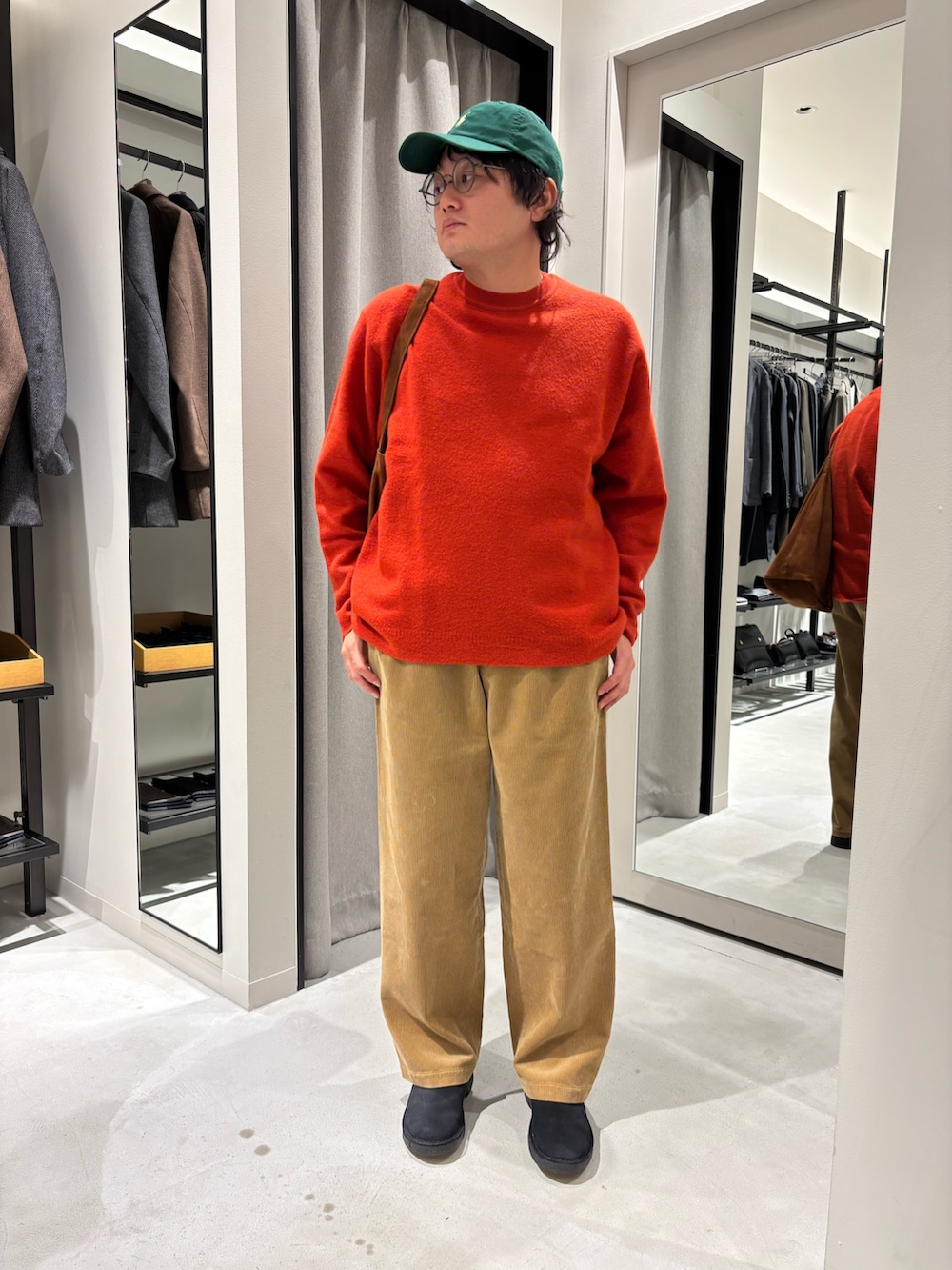 レッド系のニット/セーター、ブラウン系のその他パンツ、ブラック系のその他シューズを着用したメンズの秋コーディネートの2枚目の写真