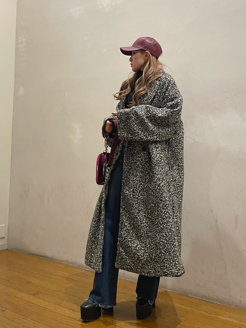 ブルー系のデニムパンツ、パープル系のショルダーバッグ、その他のチェスターコートを着用したレディースの冬コーディネートの2枚目の写真