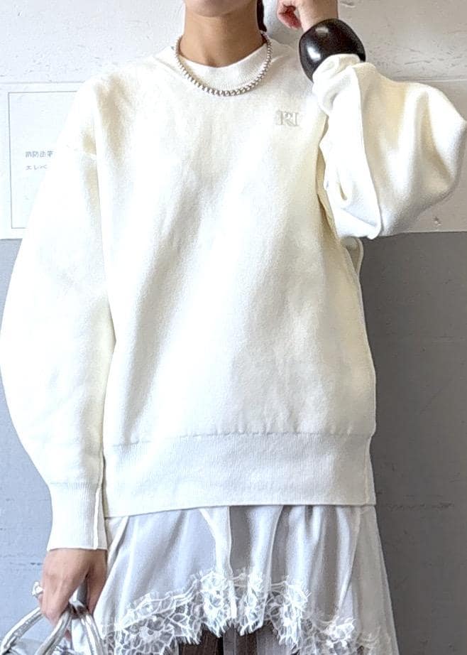 シルバー系のショルダーバッグ、ホワイト系のニット/セーター、ブラック系のブーツを着用したレディースの秋コーディネートの4枚目の写真