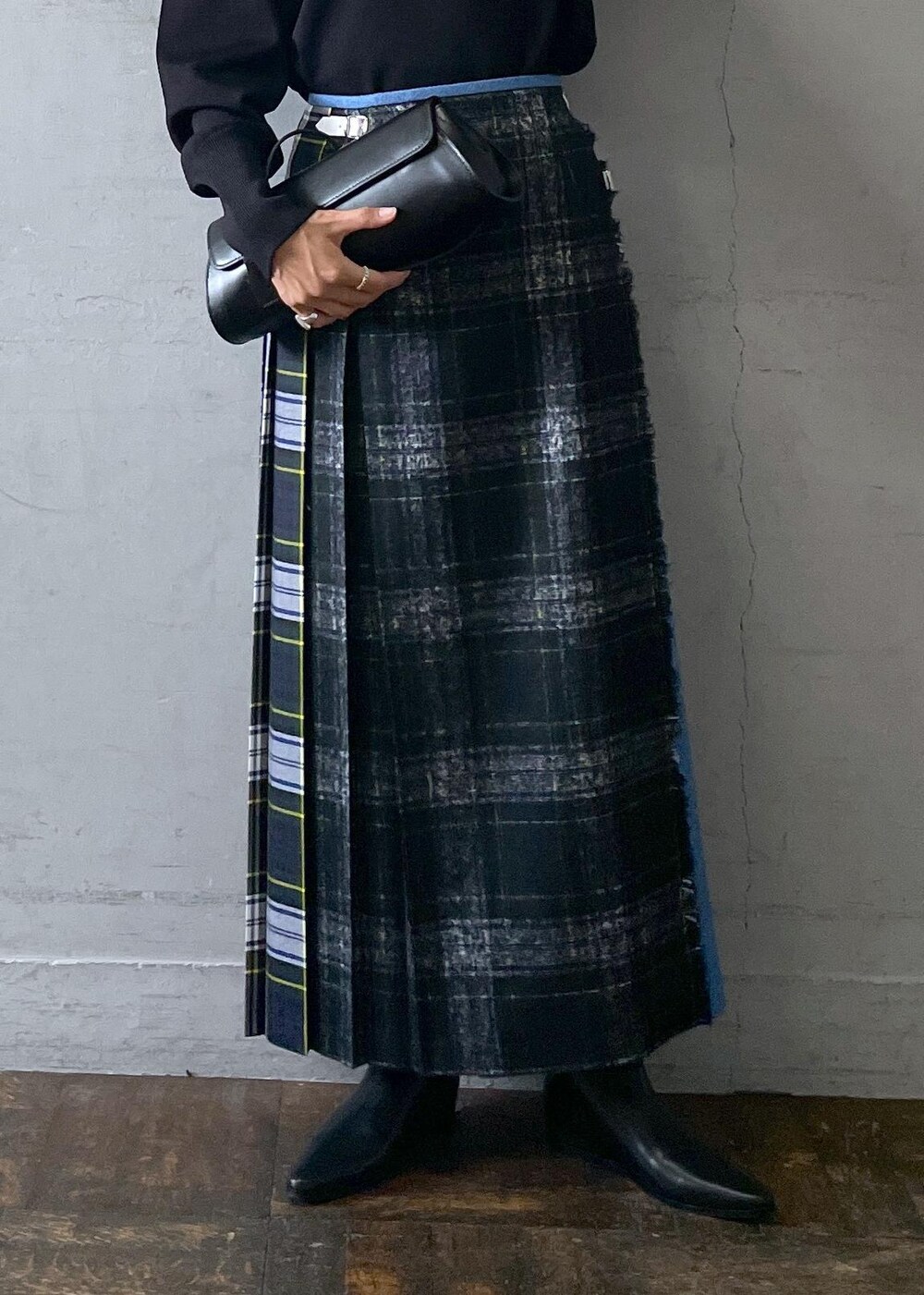 ブラック系のショルダーバッグ、ブラック系のブーツ、ブラック系のスカートを着用したレディースの秋コーディネートの7枚目の写真