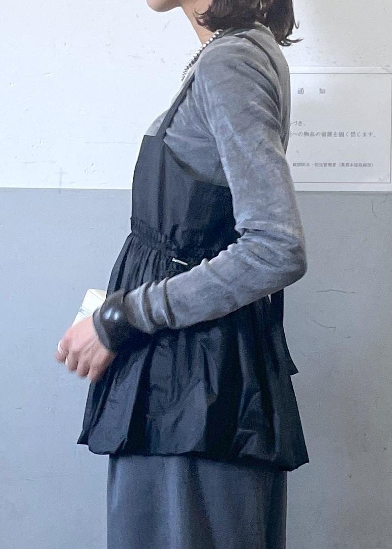 ブラック系のパンプス、グレー系のスラックス、ブラック系のTシャツ/カットソーを着用したレディースの冬コーディネートの4枚目の写真