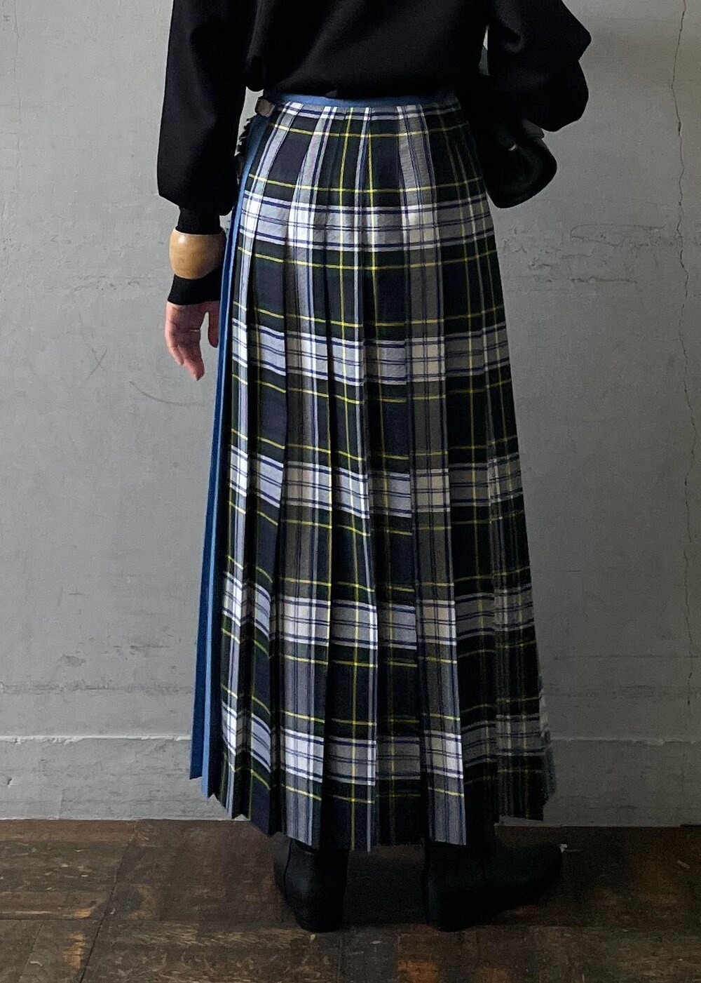 ブラック系のショルダーバッグ、ブラック系のブーツ、ブラック系のスカートを着用したレディースの秋コーディネートの9枚目の写真