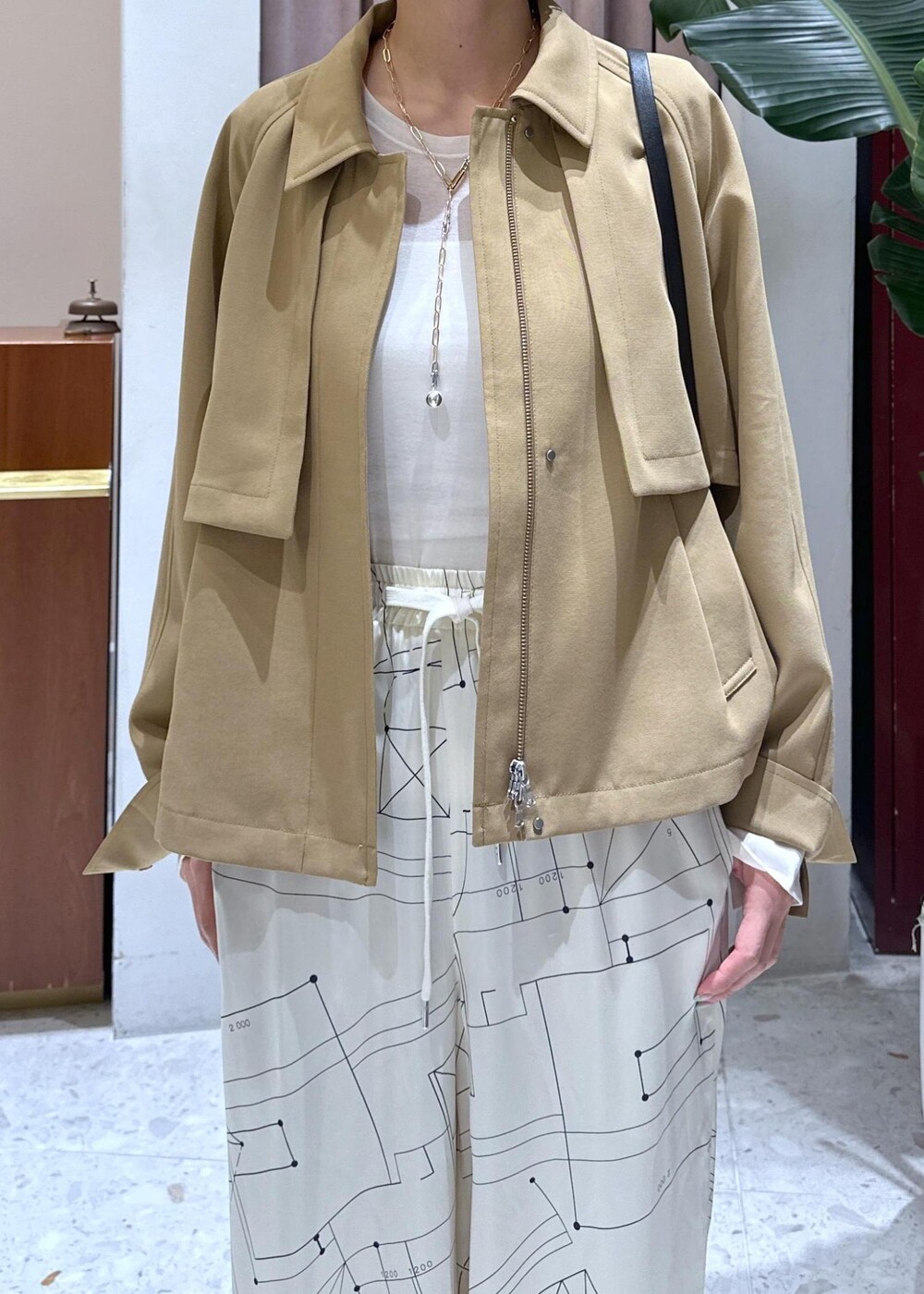 ホワイト系のTシャツ/カットソー、ブラック系のパンプス、イエロー系のブルゾンを着用したレディースの春コーディネートの4枚目の写真