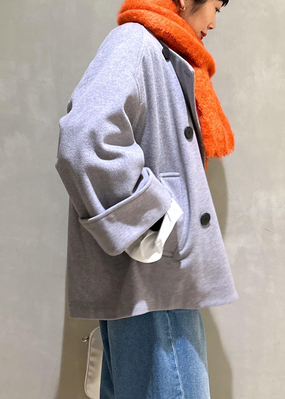 ホワイト系のTシャツ/カットソー、シルバー系のボストンバッグ、グレー系のその他アウターを着用したレディースの冬コーディネートの7枚目の写真