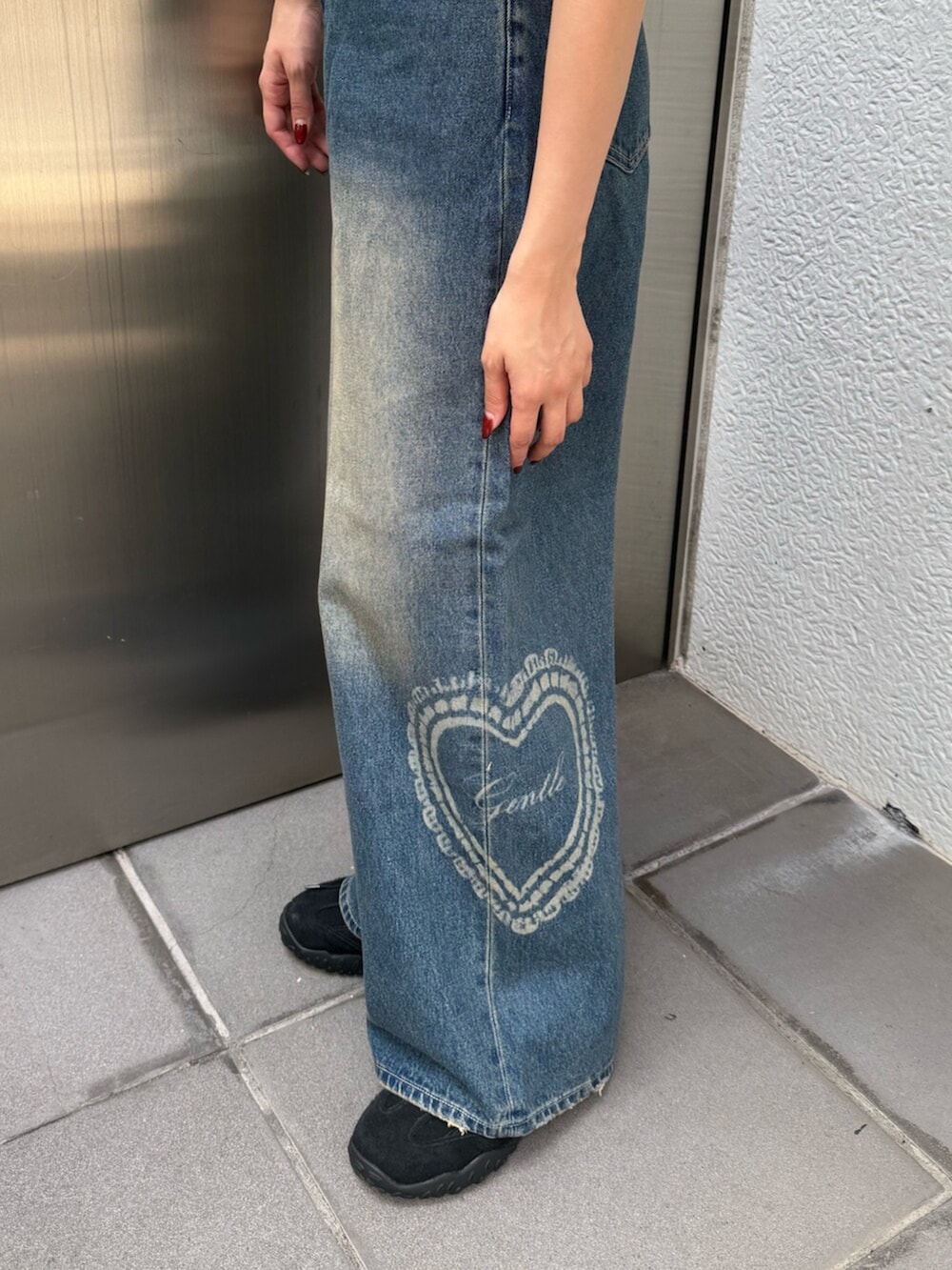 ブルー系のデニムパンツ、レッド系のTシャツ/カットソー、ブラウン系のスニーカーを着用したレディースの夏コーディネートの7枚目の写真