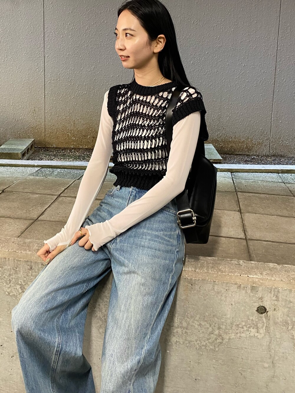 ブルー系のデニムパンツ、ブラック系のタンクトップ、ホワイト系のTシャツ/カットソーを着用したレディースの春コーディネートの3枚目の写真