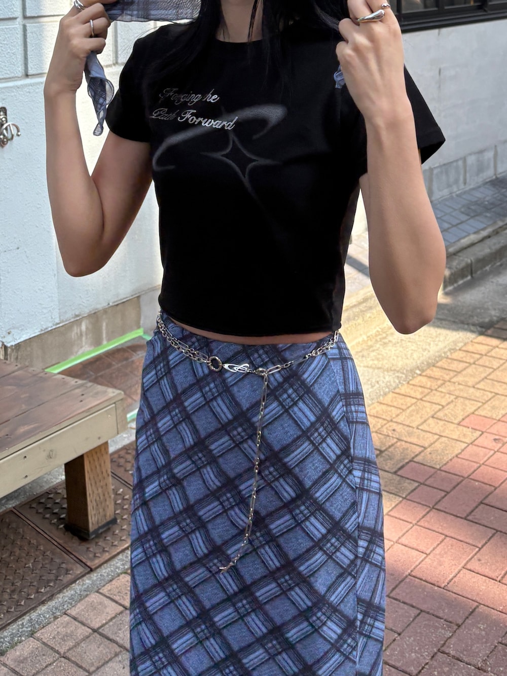 ブルー系のスカート、ブラック系のローファー、ブラック系のTシャツ/カットソーを着用したレディースの夏コーディネートの2枚目の写真