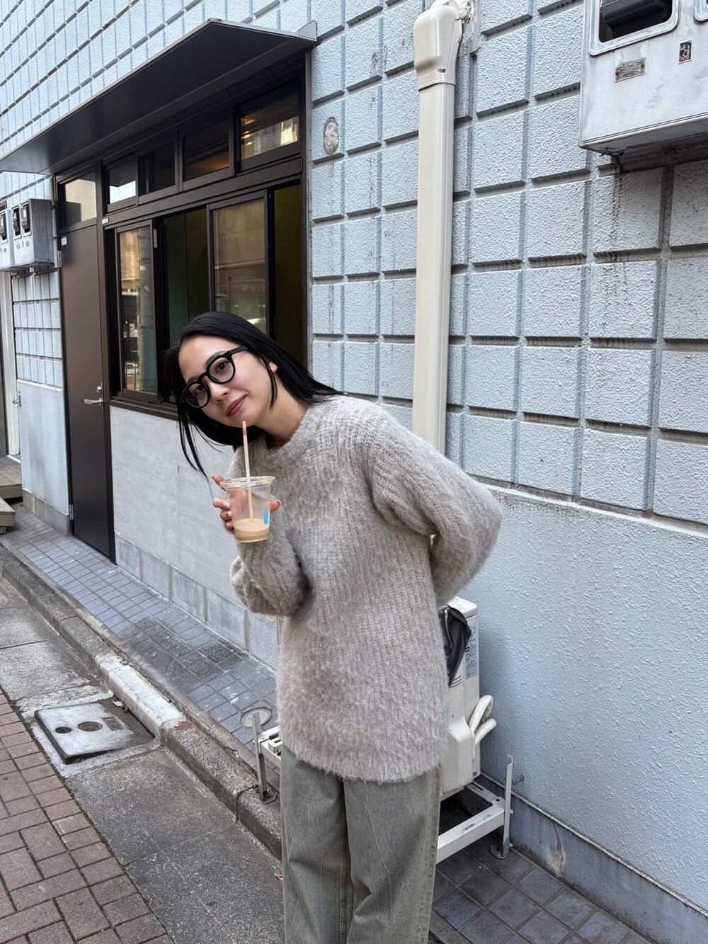 ブルー系のデニムパンツ、ホワイト系のニット/セーターを着用したレディースの秋コーディネートの3枚目の写真