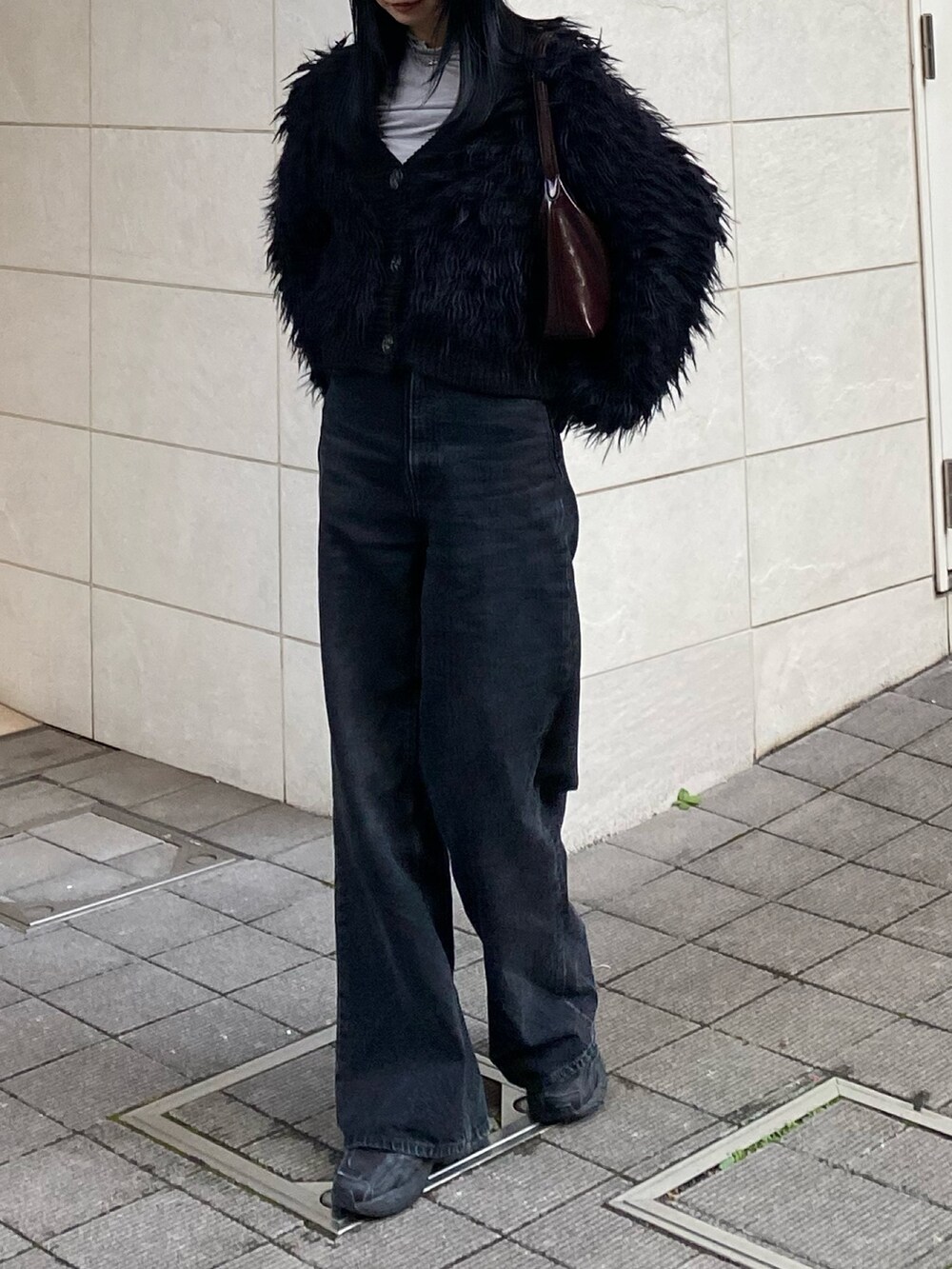 ブラック系のカーディガン/ボレロ、ブラック系のデニムパンツを着用したレディースの秋コーディネートの3枚目の写真