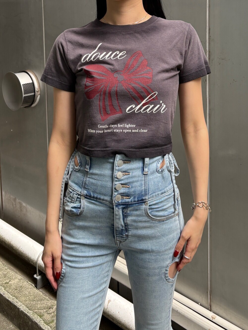 ブラック系のサンダル、ブラック系のTシャツ/カットソー、ブルー系のデニムパンツを着用したレディースの夏コーディネートの5枚目の写真
