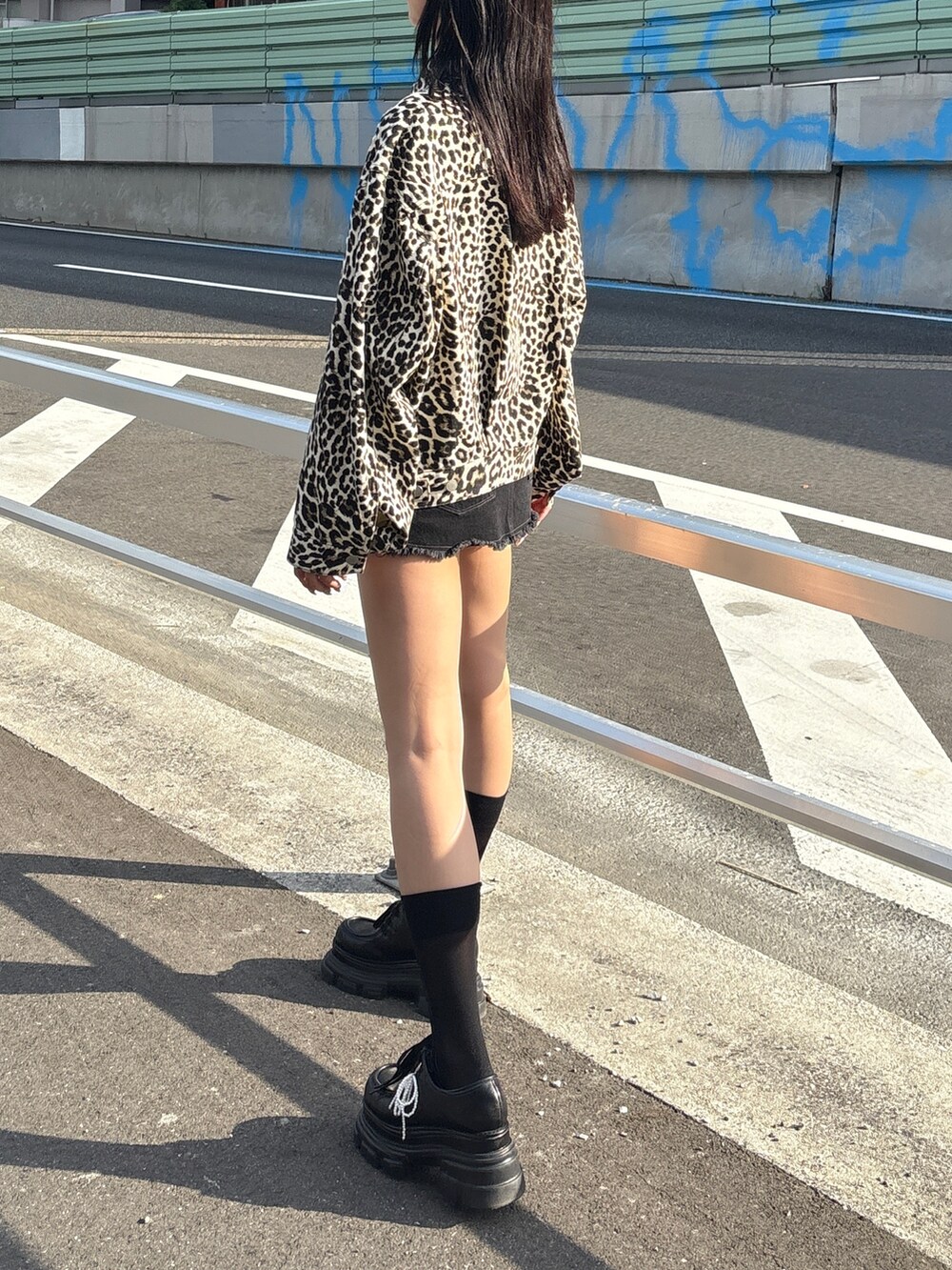 ホワイト系のブルゾン、ブラック系のスカート、ブラック系のローファーを着用したレディースの秋コーディネートの4枚目の写真