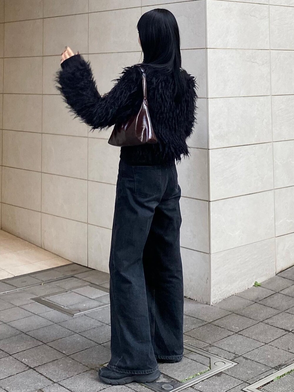 ブラック系のカーディガン/ボレロ、ブラック系のデニムパンツを着用したレディースの秋コーディネートの2枚目の写真