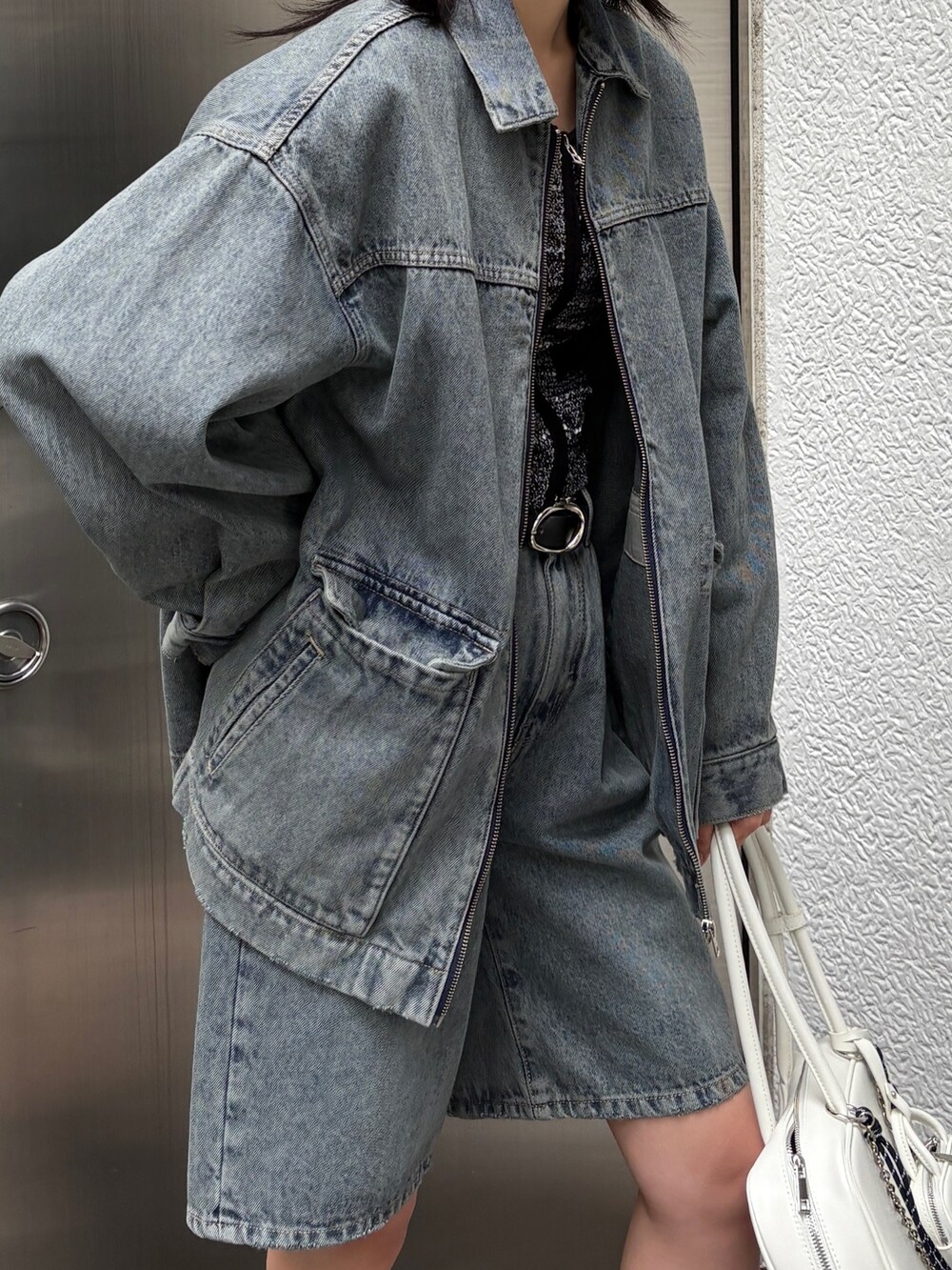 ブルー系のブルゾン、ブルー系のデニムパンツ、ブラウン系のブーツを着用したレディースの冬コーディネートの3枚目の写真