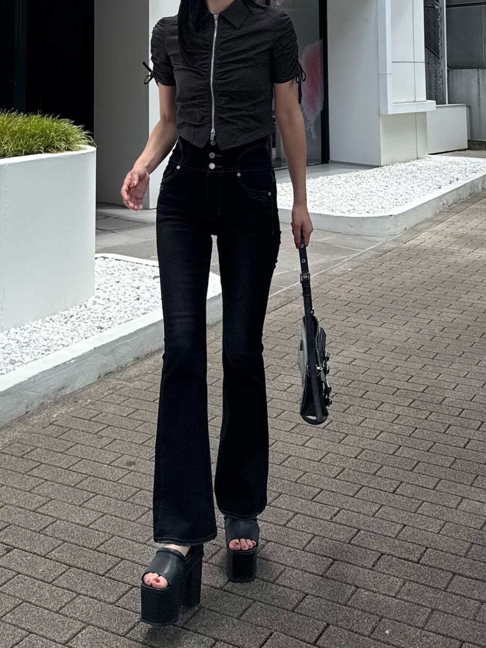 ブラック系のデニムパンツ、ブラック系のシャツ/ブラウス、ブラック系のサンダルを着用したレディースの夏コーディネートの2枚目の写真