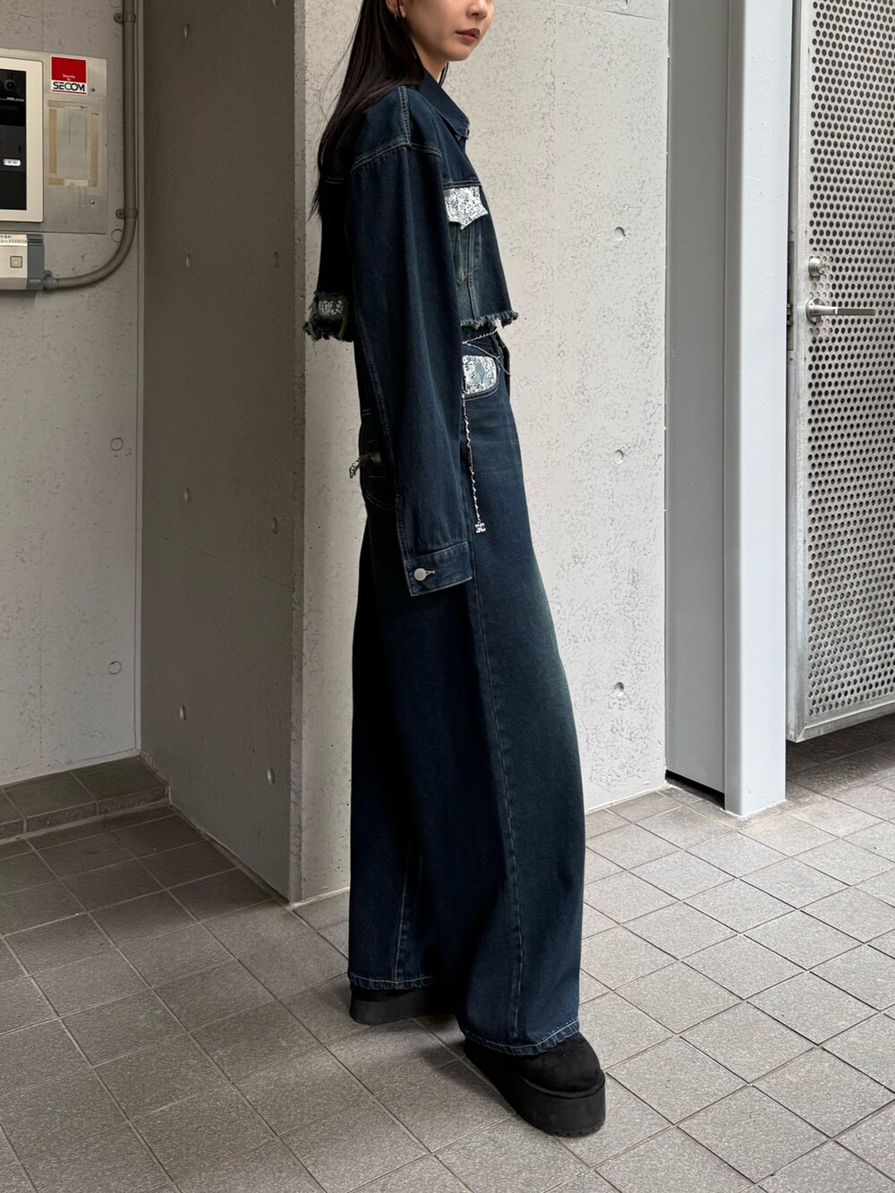 ブルー系のデニムパンツ、ブルー系のブルゾン、ブラック系のスリッポンを着用したレディースの秋コーディネートの4枚目の写真